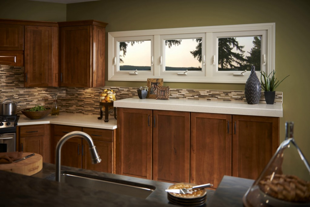 Kitchen area with awning windows by Polk County Window and Door, overlooking trees