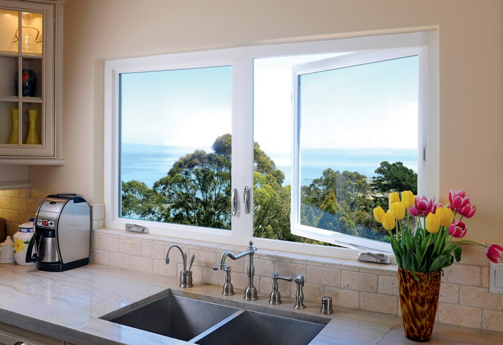 Kitchen sink with sunlight through casement windows from Polk County Window and Door