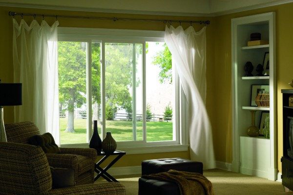 Living room with sunlight shining through slider windows from Polk County Window and Door